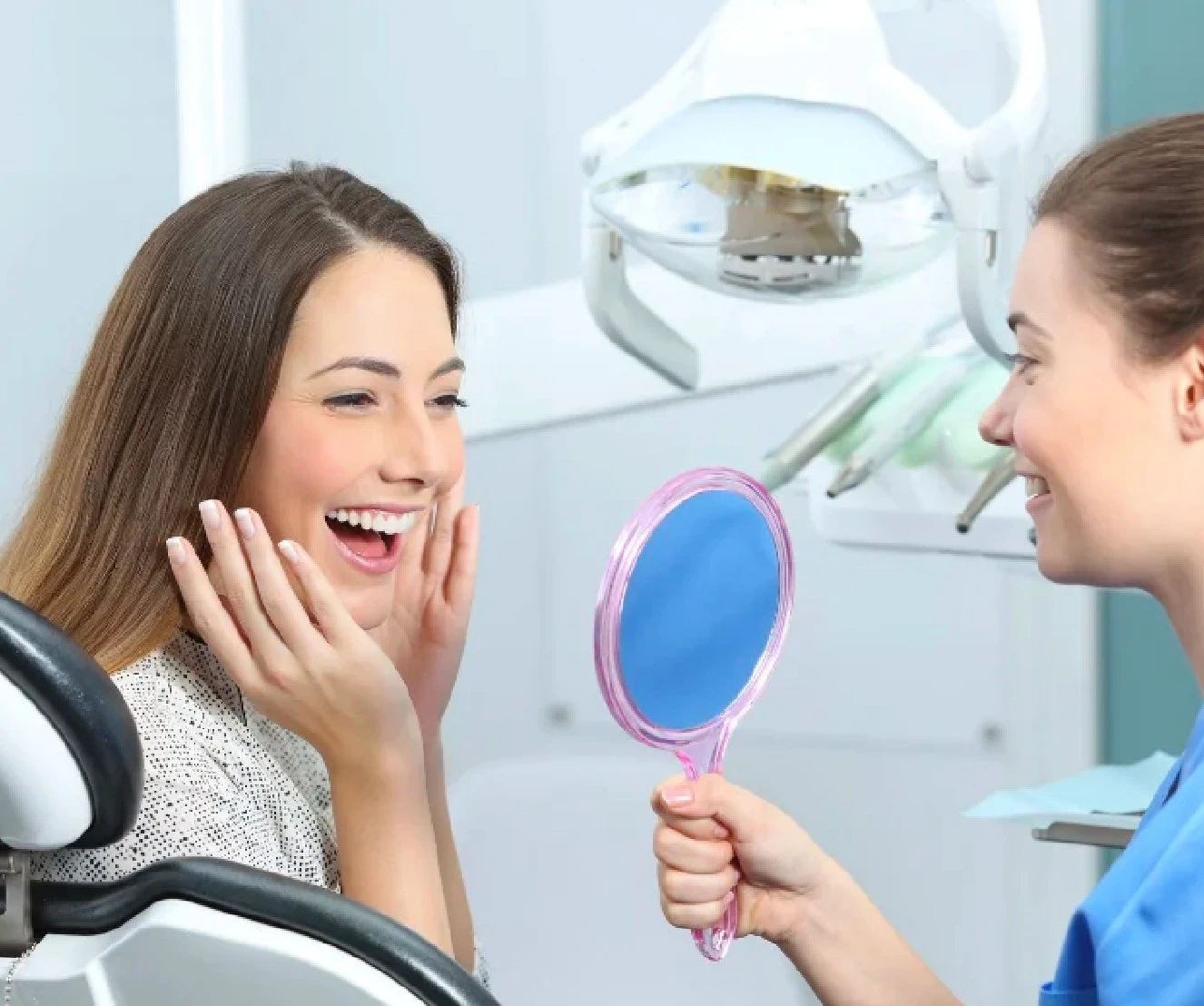 Patient checking her smile with a mirror after dental treatment at Smile Center Turkey